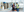 Two men stood in a warehouse reviewing documents.